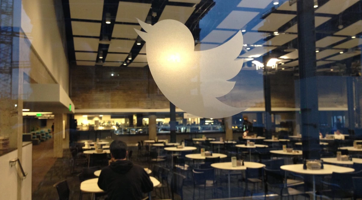 A glass wall with a Twitter logo.