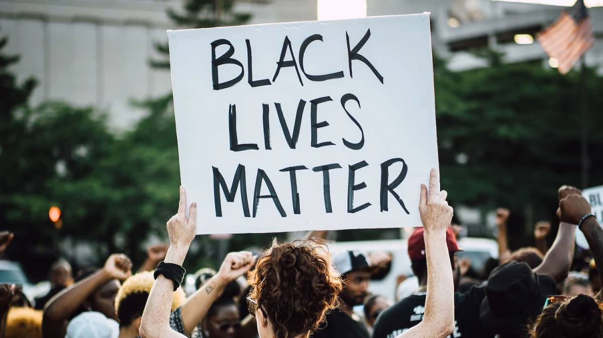 A person holds a Black Lives Matter sign at a rally.