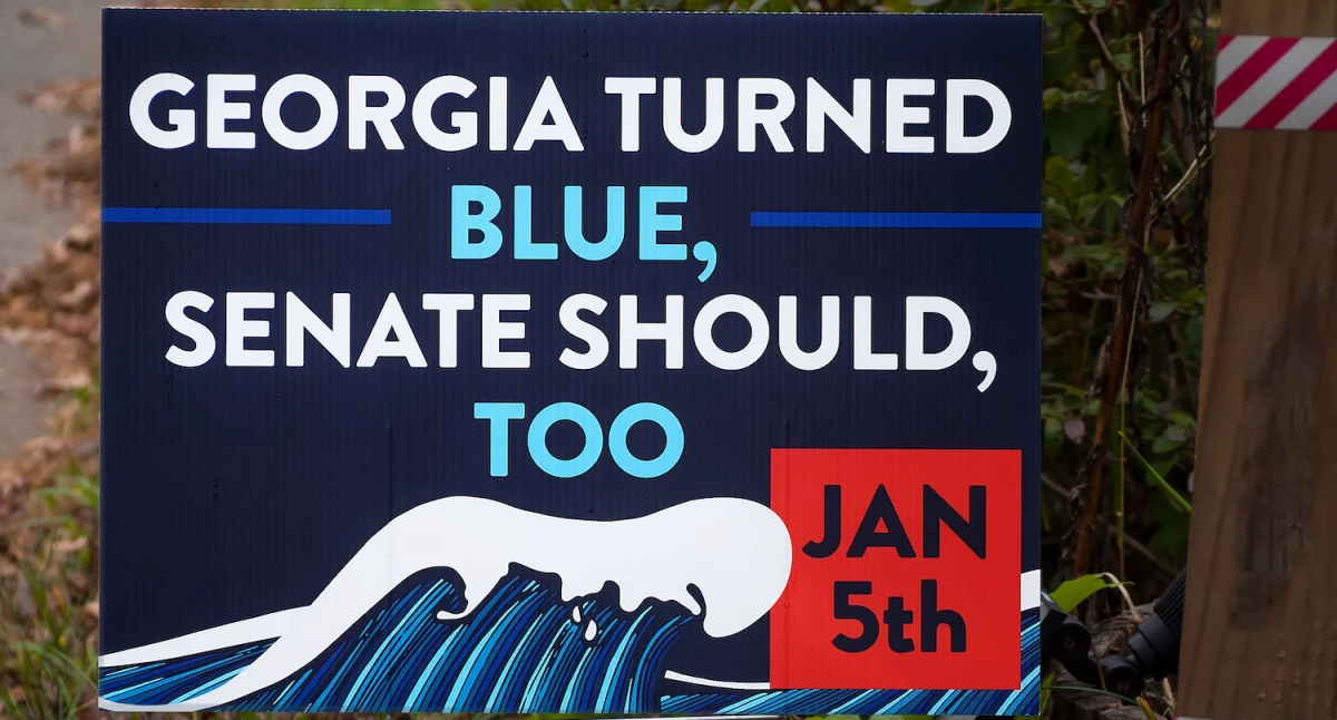 A political yard sign from the 2021 Georgia runoff election.
