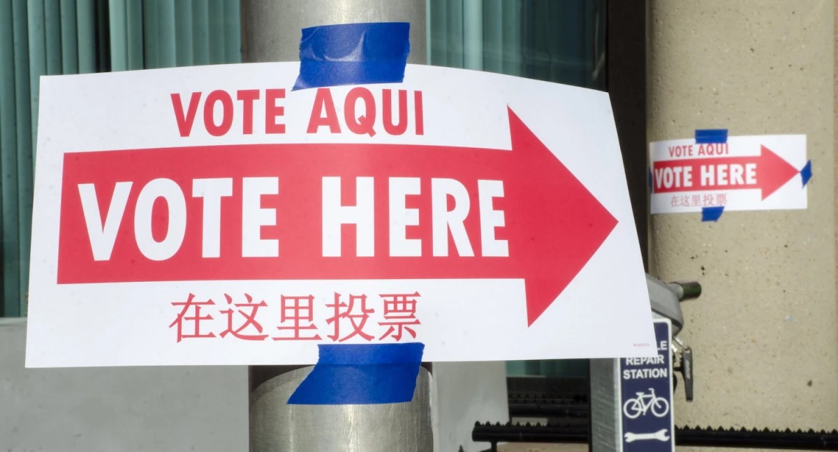 A sign with an arrow pointing voters to a polling place.